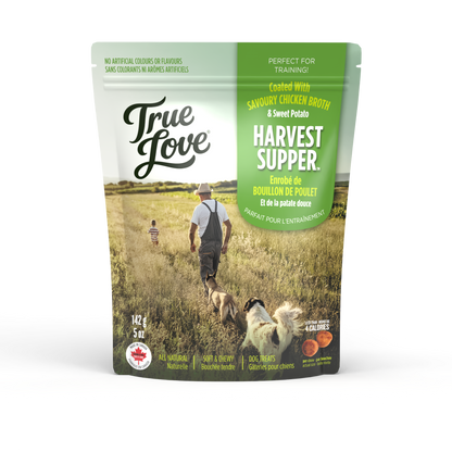 Bag of True Love dog treats with a prairie setting and two dogs on the front. Harvest Supper flavour - savoury chicken broth and sweet potato.